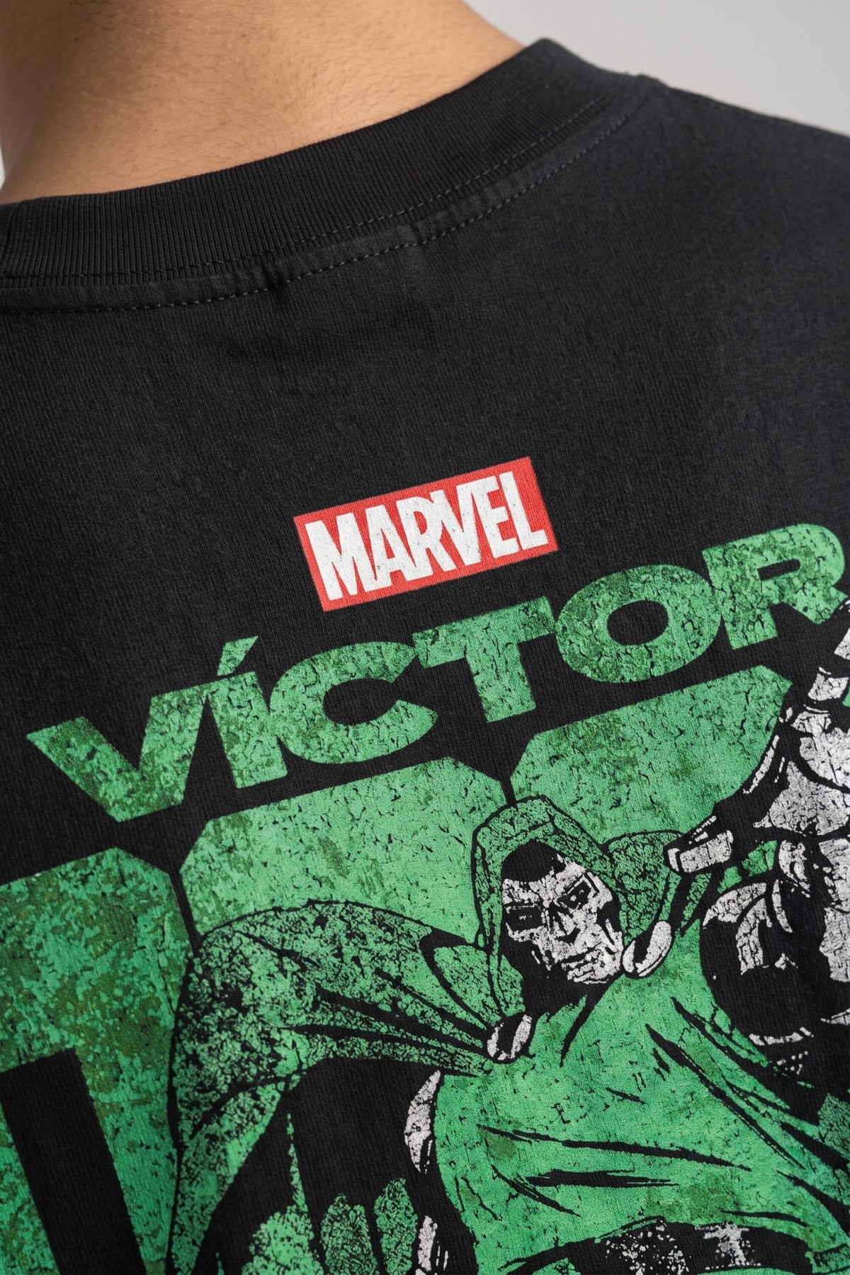 Black oversized tshirt with Marvel logo bold VICTOR green text and Dr Doom full-body illustration on back, drop shoulder boxy fit, men India - doom design shot 1