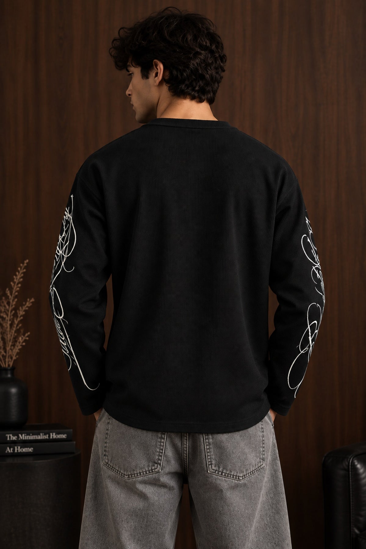 Black waffle full sleeve boxy fit tshirt with henley collar and white cursive script sleeve print, men India