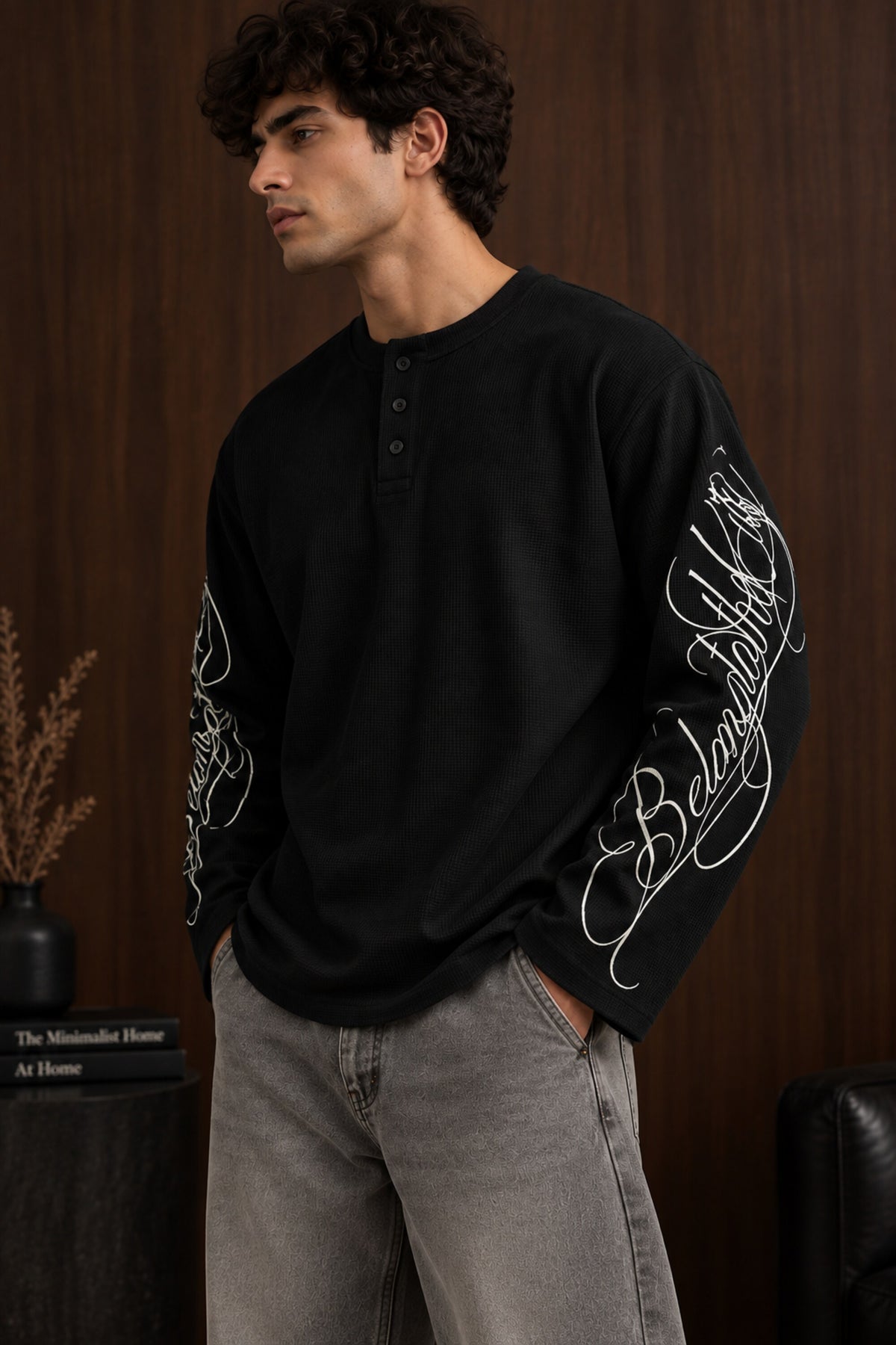 Black waffle full sleeve boxy fit tshirt with henley collar and white cursive script sleeve print, men India