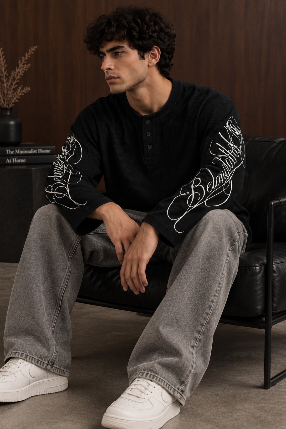 Black waffle full sleeve boxy fit tshirt with henley collar and white cursive script sleeve print, men India