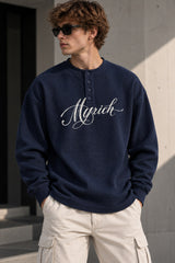White waffle full sleeve tshirt with boxy fit, henley collar and Munich cursive script print on chest, men India