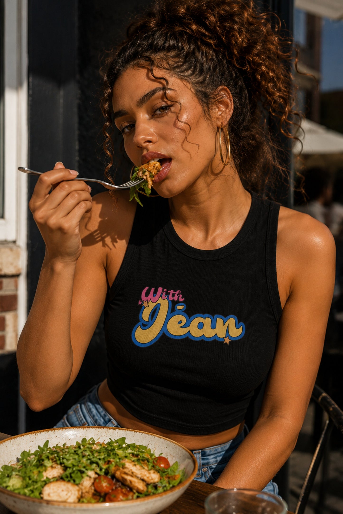 Black ribbed racerback crop tank top with With Jean retro groovy pink cursive and yellow blue text graphic Y2K aesthetic women top