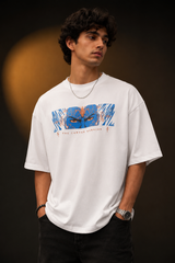 Red oversized t-shirt featuring a bold, blue and orange graphic of Ashwathama's eyes with "The Cursed Warrior" text. Model wearing the t-shirt. - white