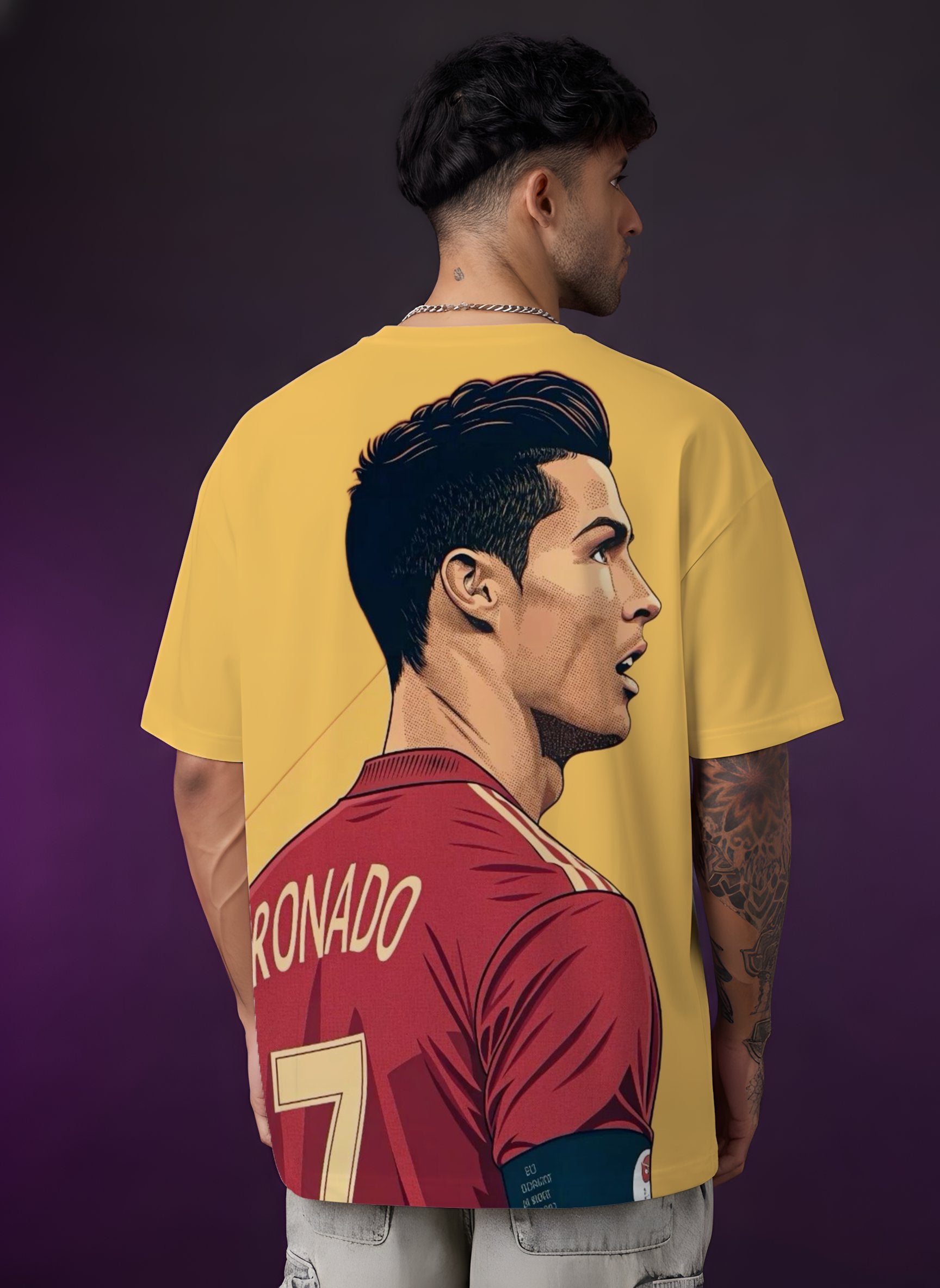 Person wearing a yellow t-shirt with a graphic of a football player and 'Ronaldo' on the back.