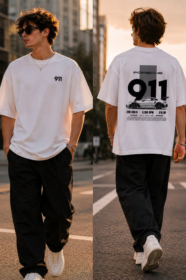 Person wearing a white t-shirt with '911' design, walking on a street.
