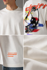 Red oversized t-shirt with 'Drift' graphic print in white and abstract black and yellow brush strokes. Focus on fabric texture and crew neckline.