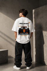 McLaren Formula 1 '2025 MCL39' design on a white oversized t-shirt, featuring a graphic of the F1 car on a checkered flag. Showcasing premium cotton fabric.