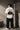 McLaren Formula 1 '2025 MCL39' design on a white oversized t-shirt, featuring a graphic of the F1 car on a checkered flag. Showcasing premium cotton fabric.