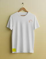 White t-shirt with a small logo on a hanger against a beige background