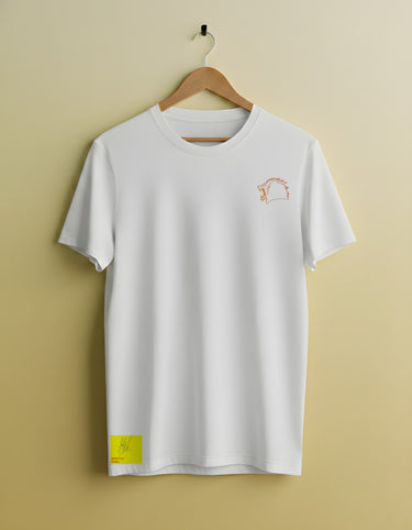 White t-shirt with a small logo on a hanger against a beige background