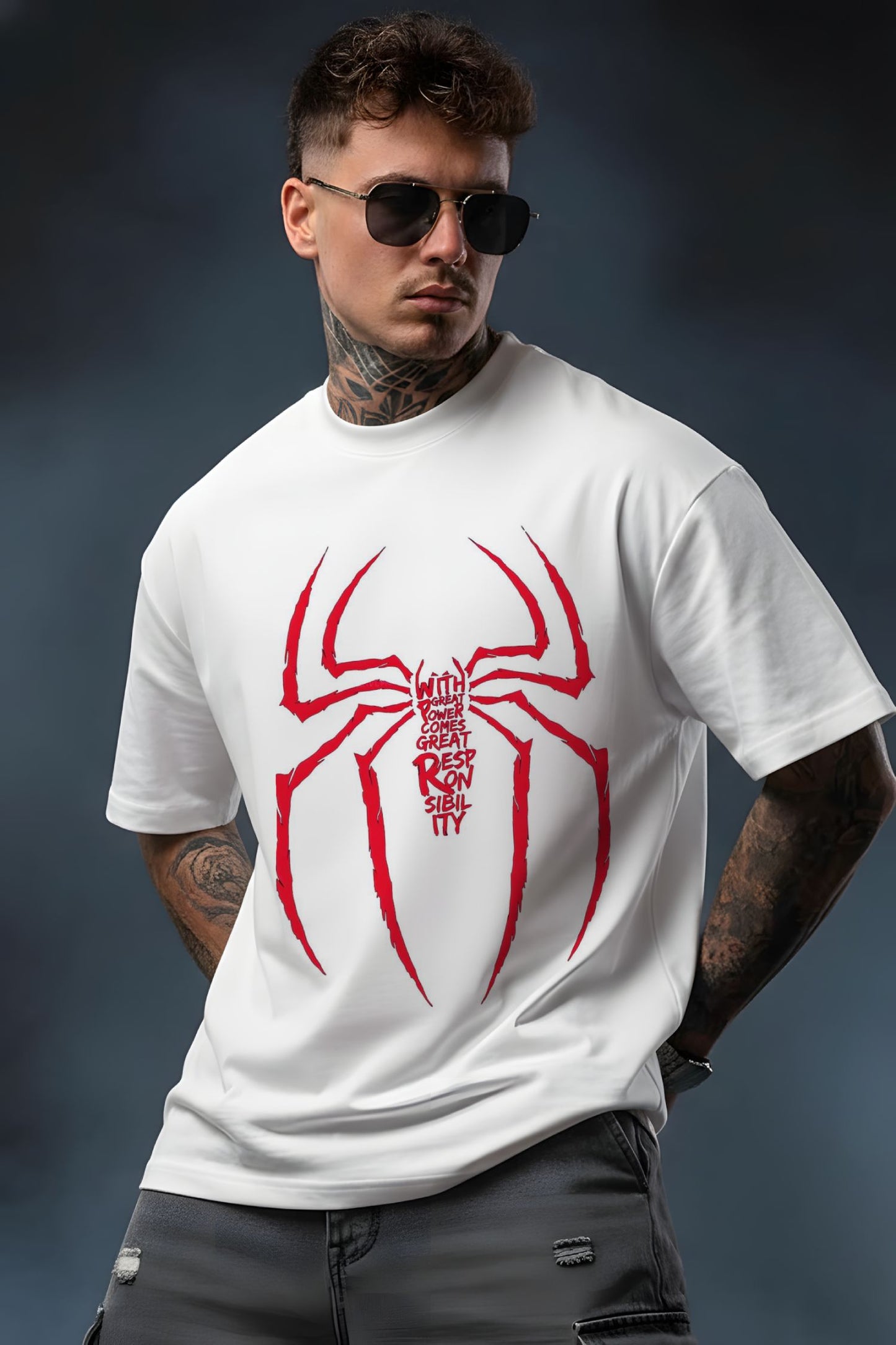 Man wearing a white t-shirt with a red spider graphic and text on a dark background