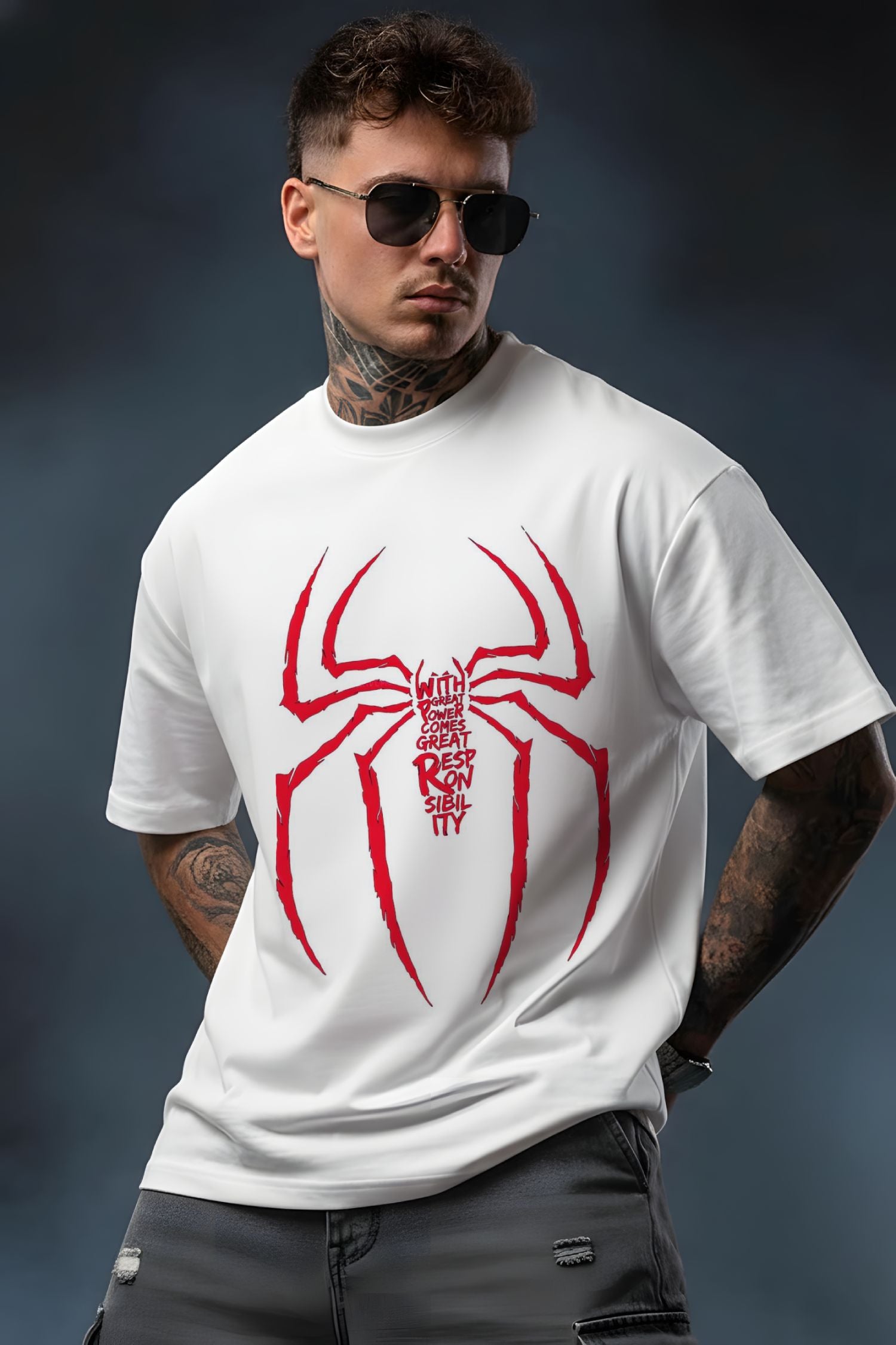 Man wearing a white t-shirt with a red spider graphic and text on a dark background
