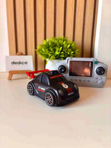 Toy car with remote control on a desk, featuring the brand 'deskco'.