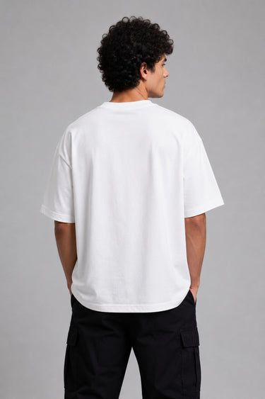 Man wearing a black kuwansugg DESIGN oversized t-shirt with a white graphic print of a knight on a horse. The t-shirt is made of premium cotton.