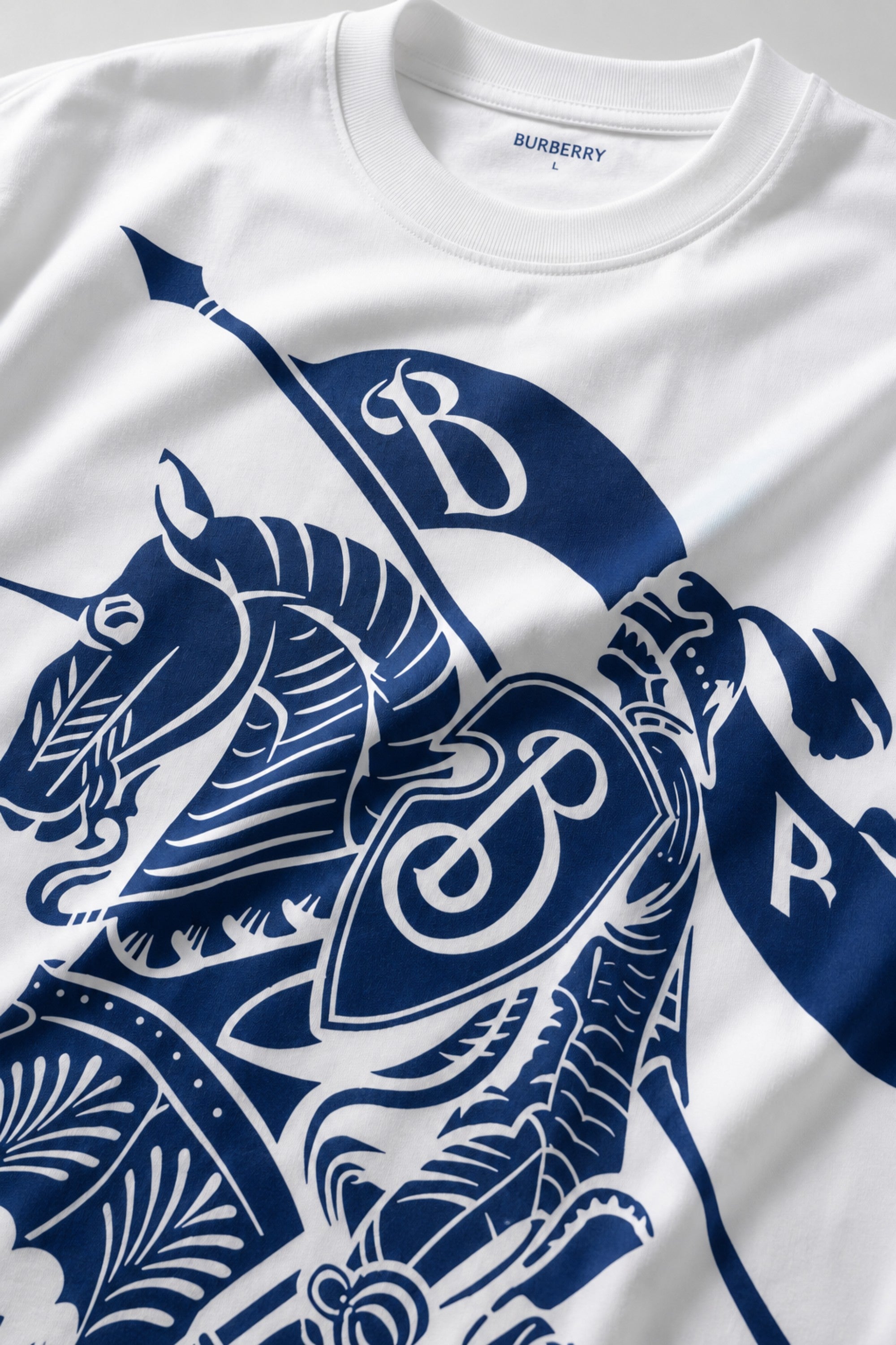 Man wearing a black kuwansugg DESIGN oversized t-shirt with a white graphic print of a knight on a horse. The t-shirt is made of premium cotton. - white