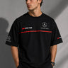 Black Mercedes-Benz and AMG oversized t-shirt with red stripe detail. Features the iconic Mercedes-Benz star logo and AMG lettering. Styled for a premium streetwear look. - black