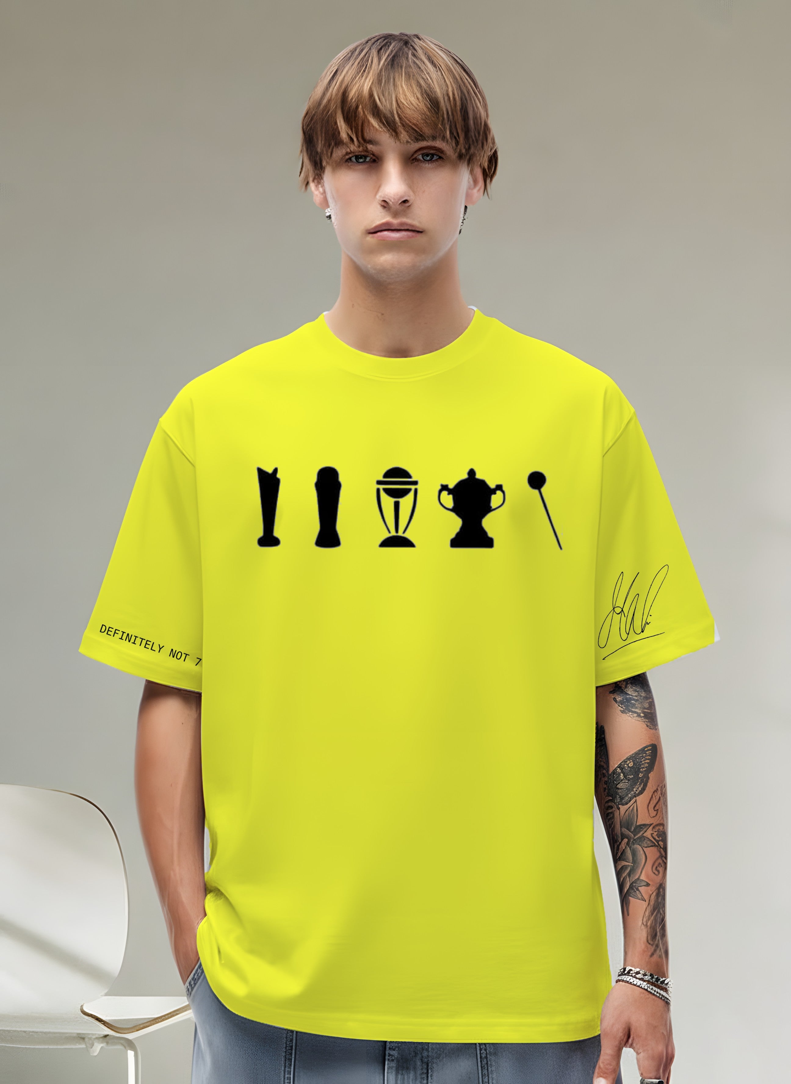 Person wearing a bright yellow t-shirt with black graphics on a neutral background