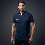 Man wearing a navy blue polo shirt with a logo on a dark background