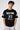 Man wearing a black t-shirt with 'New York 23 Brooklyn' text on a white background