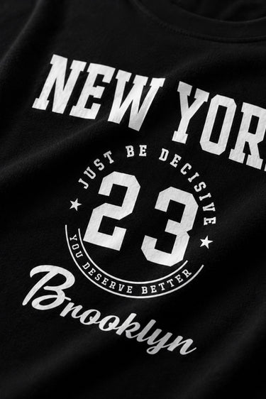 Black t-shirt with white text and numbers on a dark background