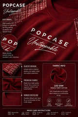 Dark red POPCASE 'Unstoppable' oversized t-shirt with white raised print, featuring ethnic patterned sleeves. Close-up shot showcasing fabric texture and print detail.