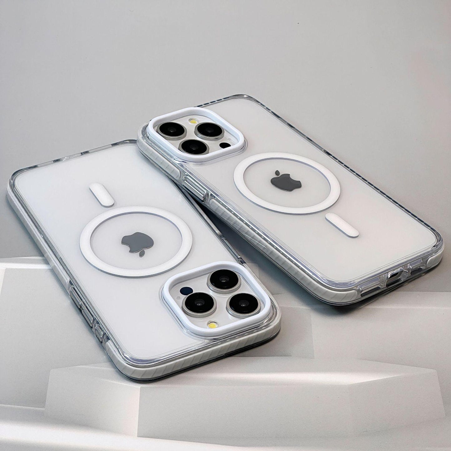 Two clear phone cases with Apple logo on a light gray background