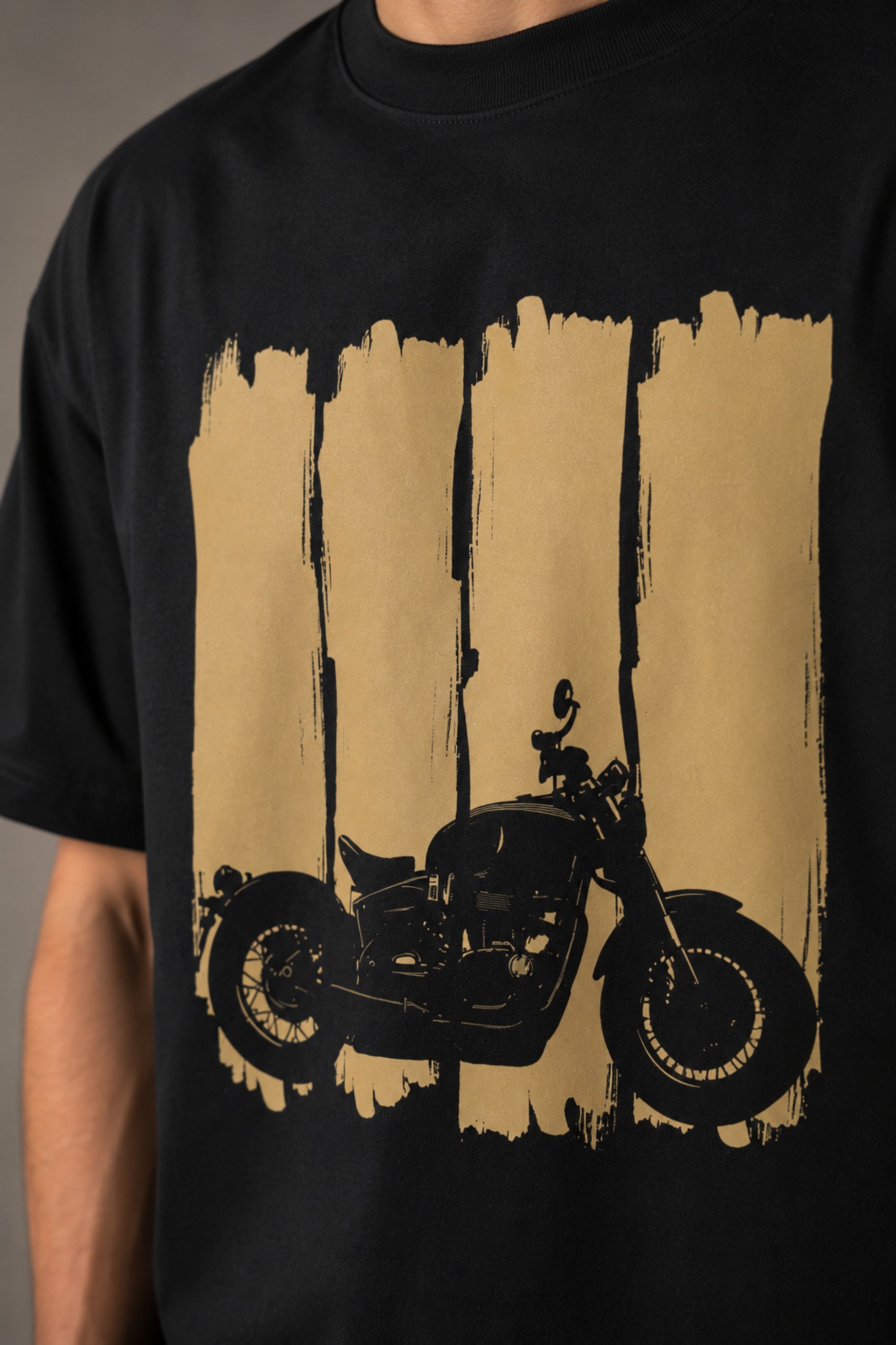 Back view of a man wearing an ENFIELD DESIGN black oversized t-shirt against a textured grey background. Features relaxed fit and premium cotton. - 4