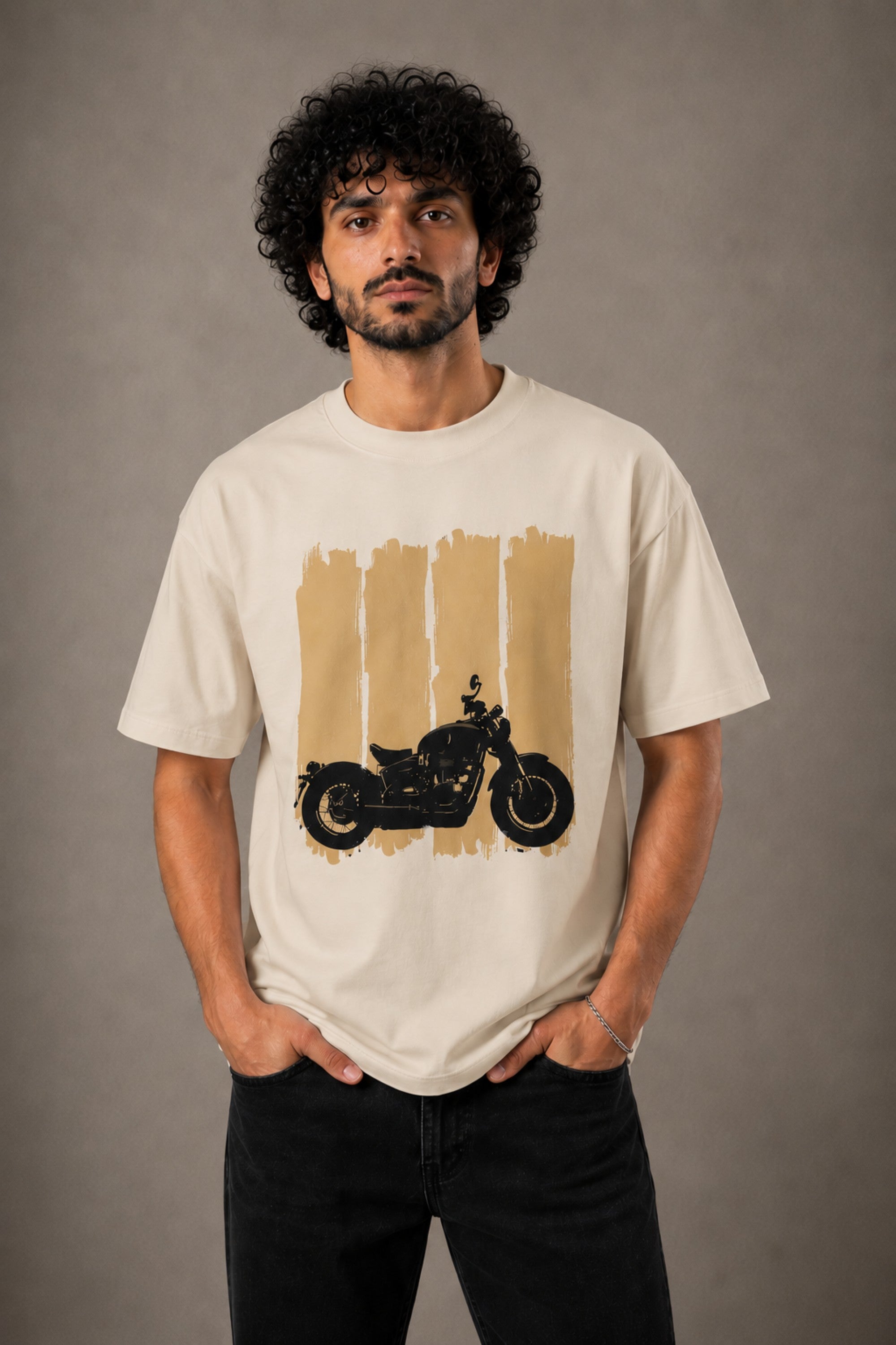 Back view of a man wearing an ENFIELD DESIGN black oversized t-shirt against a textured grey background. Features relaxed fit and premium cotton. - beige