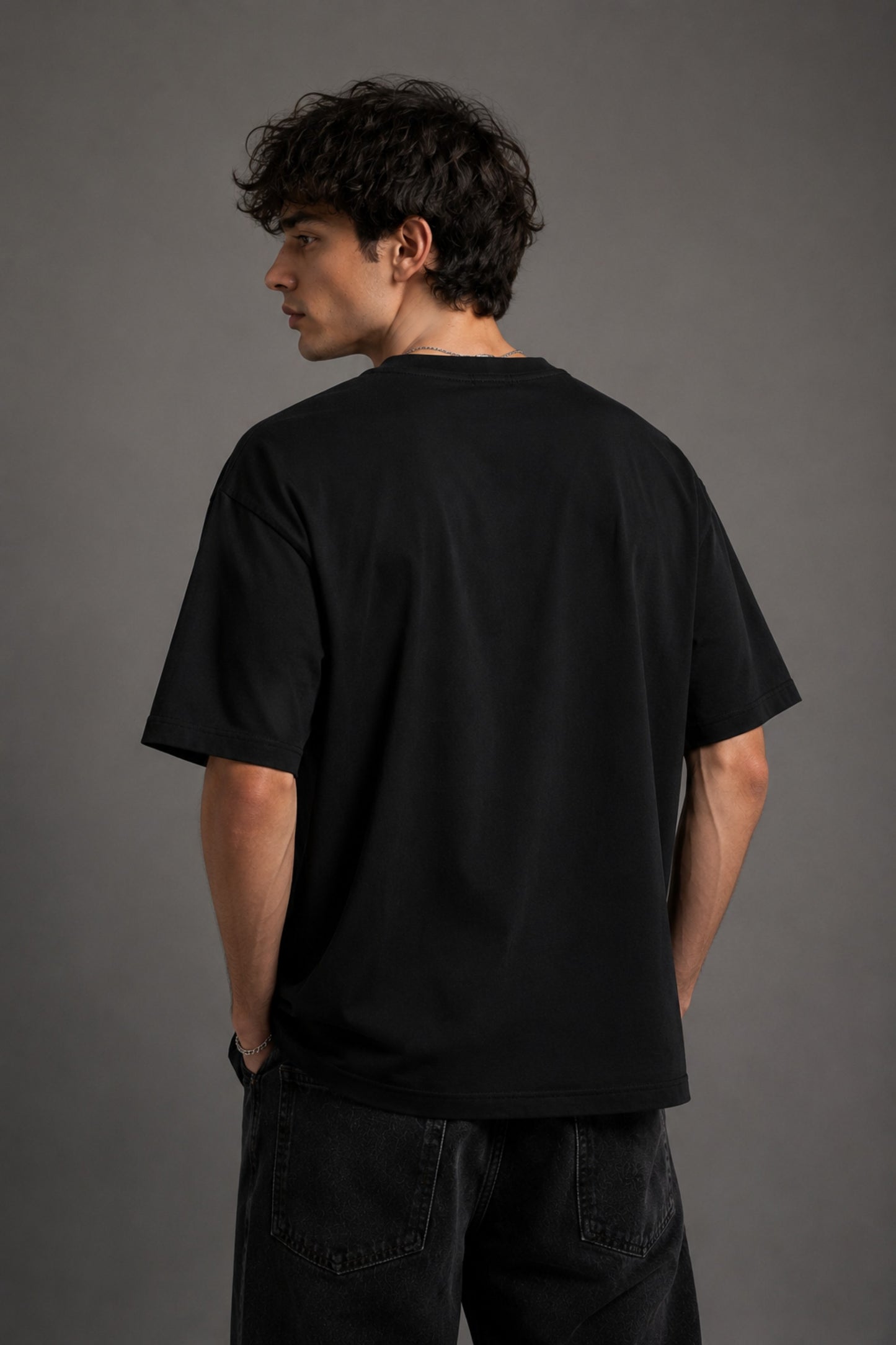 Beige oversized t-shirt with a detailed vintage-style grey snake graphic and 'MOVE IN SILENCE' text. The fabric is soft-washed premium cotton.