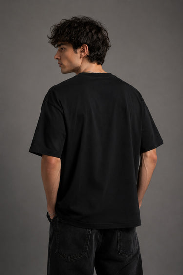 Beige oversized t-shirt with a detailed vintage-style grey snake graphic and 'MOVE IN SILENCE' text. The fabric is soft-washed premium cotton.