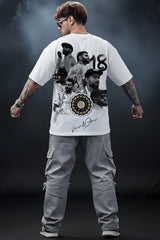 Person wearing a white Virat t-shirt with graphic designs and text, standing against a dark background.