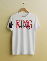 White t-shirt with 'KING' printed in red and black on a beige background