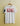 White t-shirt with 'KING' printed in red and black on a beige background