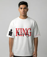 Person wearing a white t-shirt with 'KING 18' printed on it against a gray background