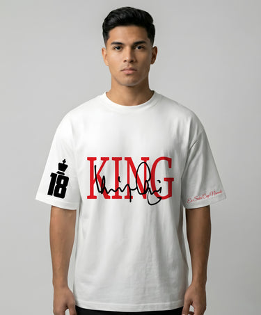 Person wearing a white t-shirt with 'KING 18' printed on it against a gray background